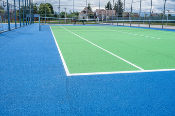 Part of the synthetic grass tennis court with markup