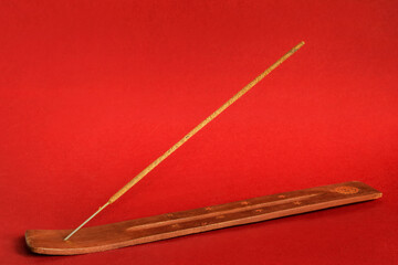 Incense stick on red background