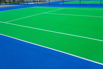 Part of the synthetic grass tennis court with markup