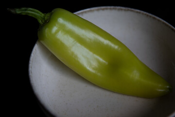 Green pepper at dish as healthy food -ingredient , basic light no photoshoped .