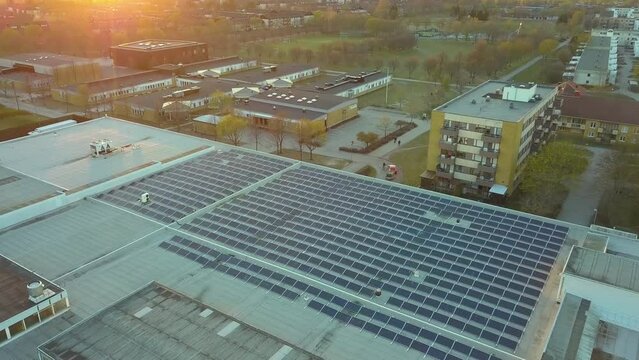 Electric photovoltaic solar panels installed on shopping mall building rooftop for production of green ecological electricity. Concept of producing sustainable energy
