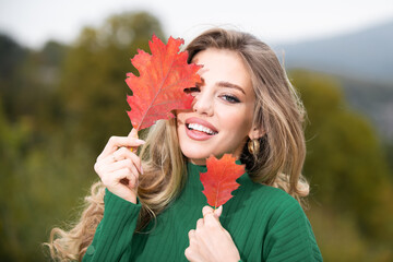 Autumn romance woman with leaves. Female model on foliage day. Dream and lifestyle. Beauty outdoor portrait. Carefree gorgeous sensual natural tender charming girl with leaf on face. Fall nature.
