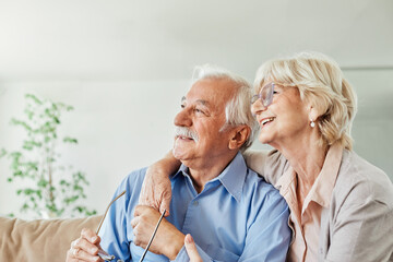 woman man senior couple happy retirement together elderly portrait active vitality bonding looking positive hug hugging bonding indoor home
