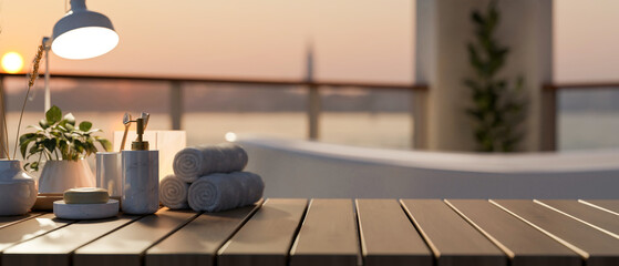 A wooden tabletop features bath accessories in a luxurious bathroom with a bathtub and sunset view.