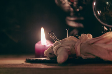 A detailed close-up shot of two lit pink candles with a dark, mystical background, emphasizing a...