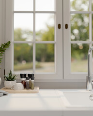 A close-up shot of a white and clean kitchen countertop against the window.