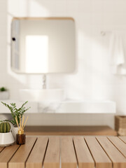 A space for showcasing products on a wooden table in a modern, luxurious white bathroom.