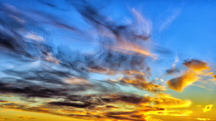 Sunset sky background with various clouds and sunlight