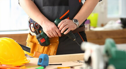 Arms of worker using electric drill closeup. Manual job DIY inspiration improvement job fix shop...