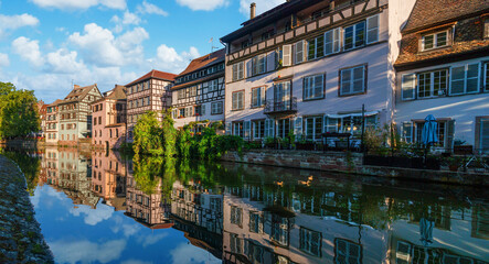 Fototapeta na wymiar Le Petite France, the most picturesque district of old Strasbourg. Half-timbered houses with reflection in waters of the Ill channels.