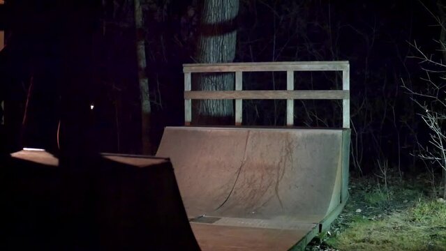 night time skateboarding a backyard miniramp