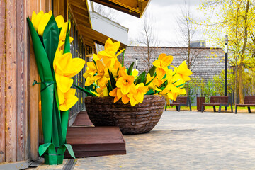 large basket with artificial yellow narcissus flowers