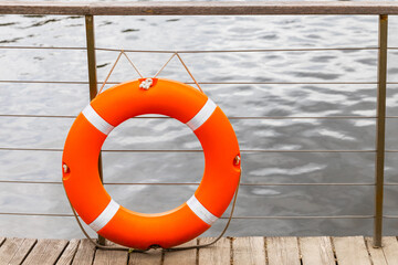 orange lifebuoy on the pier close up