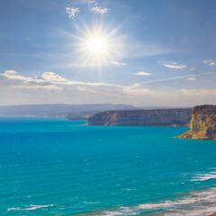 stony sea coast at the storm under a sparkle sun