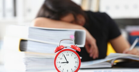 Tired and exhausted chinese woman have a lot of work with documents fall asleep. Huge pile of...
