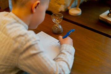 close-up in a bookstore a handsome boy at a table solves mathematical equations