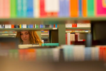 close up in a bookstore young girl chooses a new book for herself preparing for exams