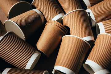 A set of paper utensils, brown cups on a brown background. Eco friendly, zero waste concept. Top...