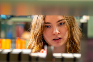 close up in a bookstore young girl chooses a new book for herself preparing for exams