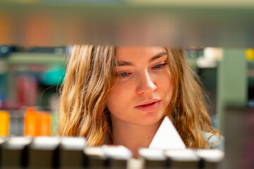 close up in a bookstore young girl chooses a new book for herself preparing for exams