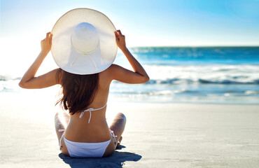Sand, relax and back of woman at beach for summer holiday, peace and adventure on vacation. Sun hat, bikini and person with sunshine by ocean for tropical, island travel and tourism in Maldives