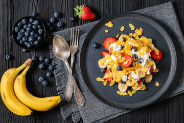 fresh berries, banana with corn flakes and yogurt