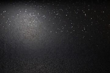 Close-up of a black textured background with sparkling points, possibly representing stars or a metaphor for beauty in darkness