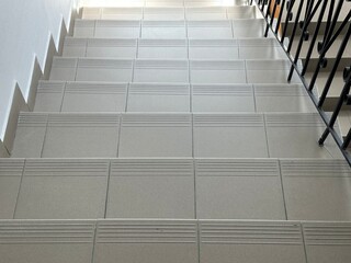 Tile staircase in an old building. Ceramic steps of a long staircase