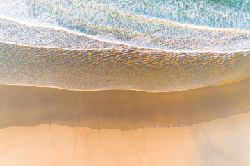 drone aerial overhead view of the foamy waves in a beach at low tide. Summer image, holidays concept
