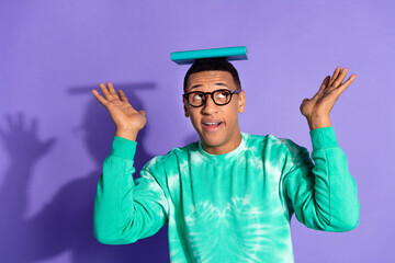Photo of excited funny guy wear teal sweatshirt eyeglasses having fun enjoy story isolated purple...