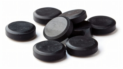 Set of activated carbon pills isolated on white