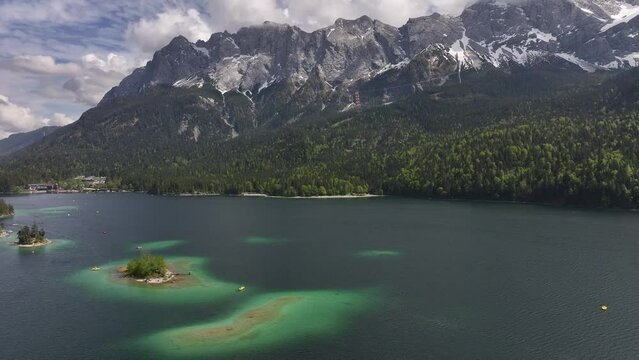 Aerial above Eibsee, Grainau, Germany, against a stunning mountainous backdrop. Concept of natural beauty and tranquility.