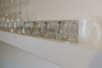 Clean cups and glasses on the shelf
