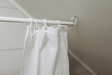 White bathroom with white shower curtain.