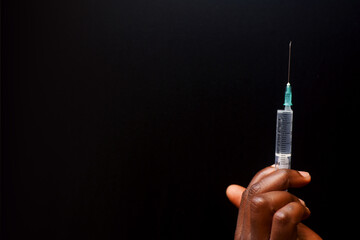 A hand holding a syringe for medical health use and hospital