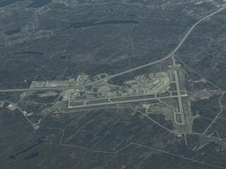 aerial landscape view of area around Halifax Stanfield International Airport in Goffs, Novo Scotia, Canada, with two runways arranged perpendicular to each other, Terminals, Hangars and Taxiways. 