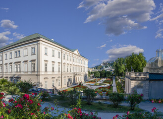 Obraz premium Salzburg, Austria, August 15 2022. Enchanting daytime shot of the Mirabell Palace Gardens. People visit them and explore. The in highlights the Hohensalzburg fort in the background.