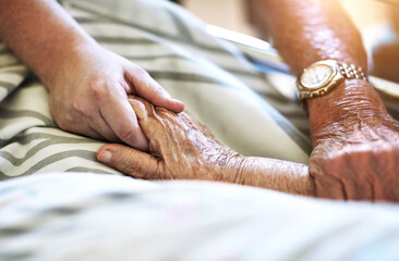 Senior person, hands and visit with hospital, closeup and elderly care or love together. Elderly...