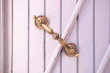 entrance wooden old carved doors Morocco in oriental style, metal door handle, traditional oriental...