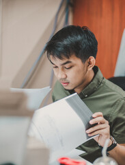 Asian person working on a computer at the office