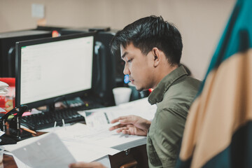 Asian person working on a computer at the office