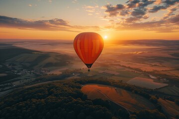 A hot air balloon rises at dawn, floating over misty fields and wooded areas bathed in soft morning light. AI Generated