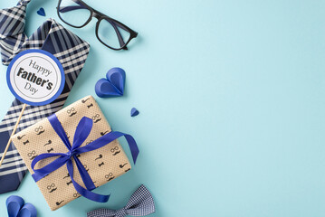 Stylish Father's Day celebration setup featuring a gift box, bow tie, glasses, and a greeting card...