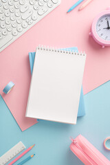 Top vertical view of an organized desk setup with pastel-colored workspace elements, featuring a...