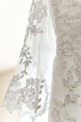 White wedding dress with delicate lace detailing on the sleeves