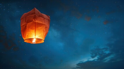 Floating lantern with flame in the night sky background