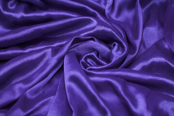 an up close view of purple silk fabric with a smooth surface