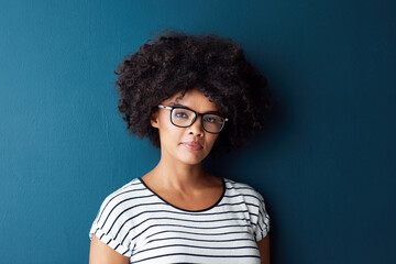 Black woman, portrait and serious with glasses for optometry or vision and on blue studio...