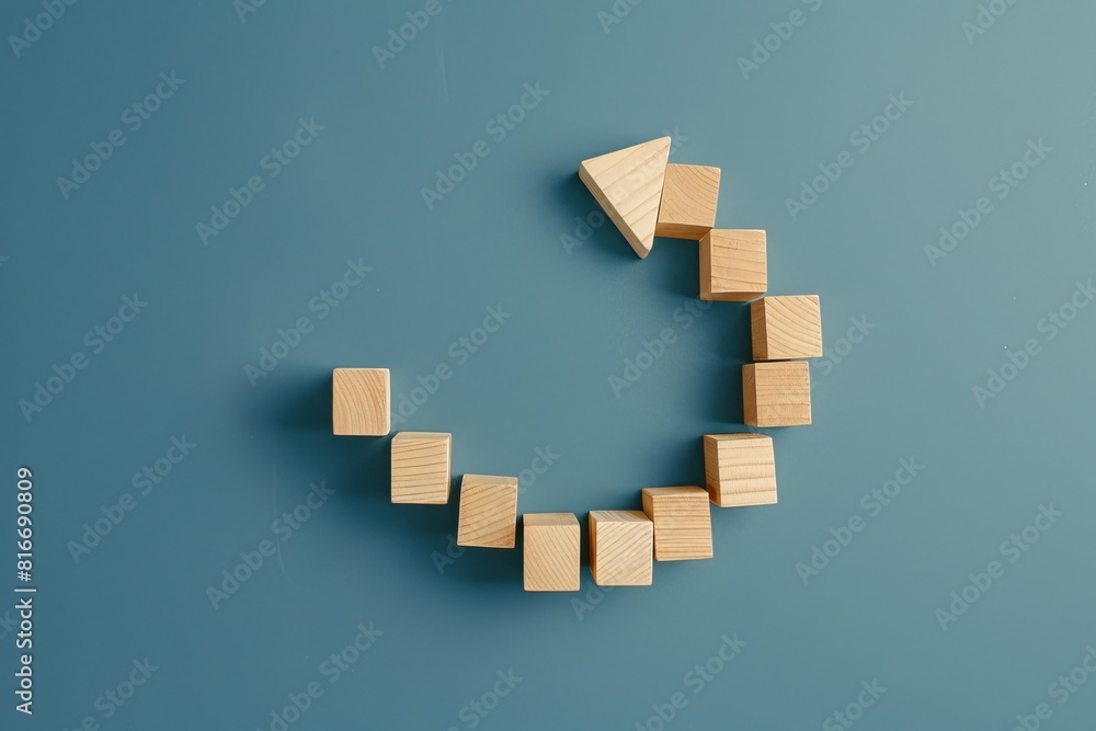 Poster a wooden arrow is made out of wooden blocks. the arrow is curved and has a spiral shape. the blocks 