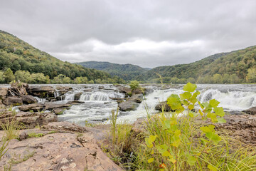 the scenic views of the river from the rocky banks at a waterfall